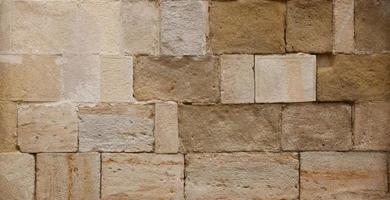 texture de mur de pierre avec beaucoup de grosses pierres brunes photo