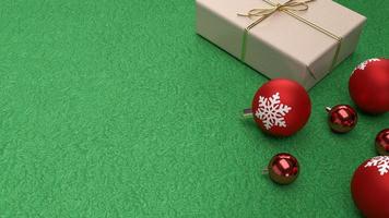 les boules de noël rouges et boîte-cadeau sur fond vert rendu 3d photo