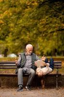 grand-père passe du temps avec sa petite-fille sur un banc dans le parc le jour de l'automne photo