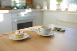 table de cuisine, carte de crédit, tasse de café ou de thé et smartphone photo