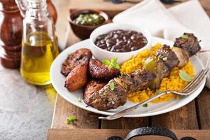 brochette de boeuf avec riz, haricots et plantains frits photo