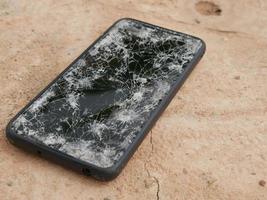 le smartphone a heurté le sol, il est tombé dans une fissure. photo