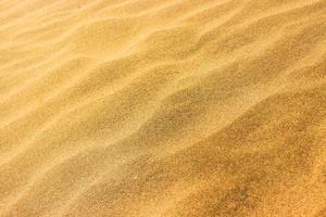 sable de texture sur la plage comme arrière-plan et texture photo
