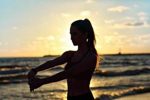 femme qui court seule au beau crépuscule sur la plage photo