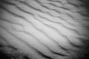 sable sur la plage en arrière-plan. texture de sable naturel, motif nature photo
