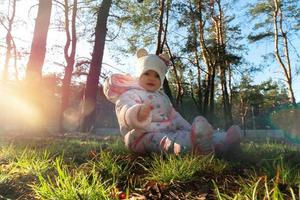 joyeuse petite fille joue avec des cônes dans le bois photo