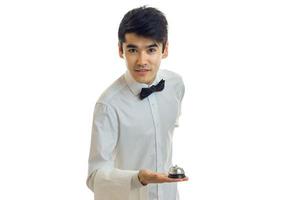 jeune serveur charmant dans une chemise blanche se pencha en avant photo