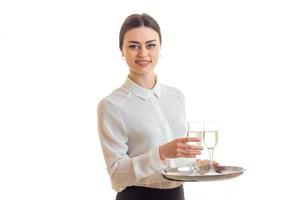 la jeune serveuse sourit et garde les verres à vin photo