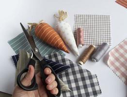 main de femme âgée tenant des ciseaux, couture et travaux d'aiguille de Pâques, artisanat facile et créatif pour la famille, décor de maison de Pâques photo