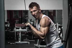 homme musclé pendant l'entraînement dans la salle de gym photo