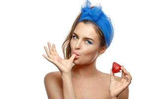 femme avec du maquillage coloré mange des fraises photo