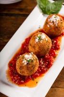 arancini, boulettes de riz italiennes farcies enrobées de chapelure photo