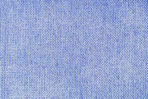 gros plan de la texture du tissu d'ameublement à tissage grossier bleu. fond textile décoratif photo