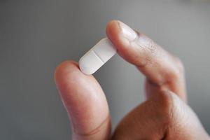 Close up of man hand holding pills with copy space photo