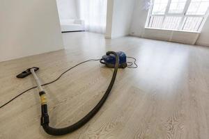 aspirateur sur fond de béton blanc dans la maison. photo