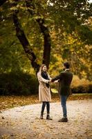 jeune couple s'amusant dans le parc d'automne photo