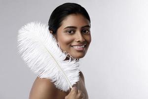 jeune et sensuelle femme indienne avec une douce plume d'autruche photo