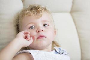 adorable petite fille aux cheveux blonds et aux yeux bleus dans une chaise photo