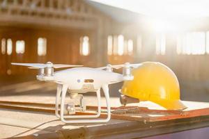 quadricoptère drone à côté d'un casque de casque sur un chantier de construction photo