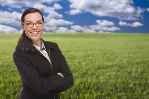 femme confiante dans un champ d'herbe regardant la caméra photo