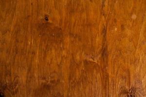 texture de fond en bois brun vintage avec noeuds et trous de clous. vieux mur en bois peint. fond abstrait marron. planches horizontales sombres en bois vintage. photo