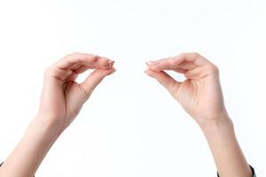 les mains des femmes l'une en face de l'autre avec les doigts serrés isolés sur fond blanc photo