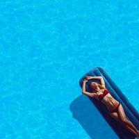 jeune femme en bikini rouge prenant un bain de soleil photo