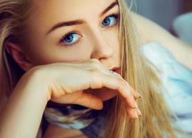 superbe jeune femme blonde regardant la caméra aux yeux bleus photo