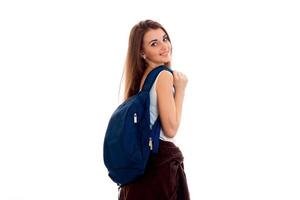 heureux, jeune, étudiants, girl, à, bleu, sac à dos, sur, épaule, sourire, appareil-photo, isolé, blanc, fond photo