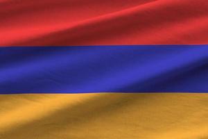 drapeau arménien avec de grands plis agitant de près sous la lumière du studio à l'intérieur. les symboles et couleurs officiels de la bannière photo