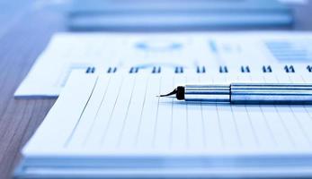 Close up sliver stylo à bille avec bloc-notes sur table en réunion photo