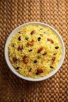 kashmiri sweet modur pulao composé de riz cuit avec du sucre, d'eau aromatisée au safran et de fruits secs photo