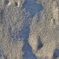 modèle de texture transparente photo réaliste de sable sur une plage