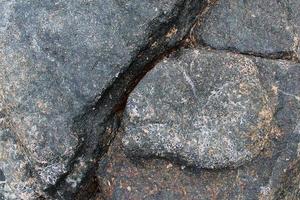 vue rapprochée sur une texture de mur de granit et de pierre en haute résolution. photo