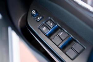 Accoudoir intérieur de porte de voiture avec panneau de commande de fenêtre, bouton de verrouillage de porte et commande de rétroviseur. photo