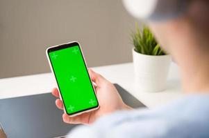applications modernes mickup.smartphone avec écran chroma vert dans les mains d'un homme méconnaissable photo