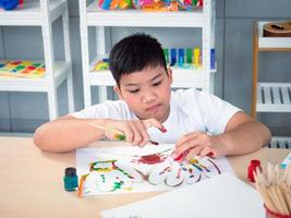 un cours d'arts créatifs de groupe joyeux pour les enfants et leur professeur dans la salle de classe, des écoliers heureux jouant à un jeu de société intéressant pendant une leçon en classe photo