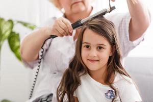 grand-mère fait friser les cheveux petite-fille photo