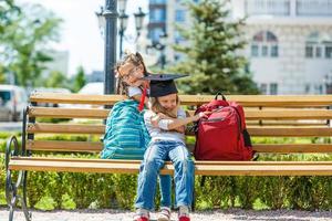 concept de carrière féminine réussie. joyeuse petite fille étudiante en mathématiques en chapeau de graduation sur fond d'école photo