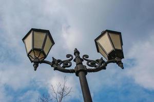 lampadaires sur poteau métallique sur fond de ciel bleu nuageux au soleil de l'après-midi. mise au point sélective. photo