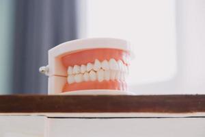 concept de stomatologie, portrait partiel d'une fille avec de fortes dents blanches regardant la caméra et souriant, les doigts près du visage. gros plan sur une jeune femme chez le dentiste, en studio, à l'intérieur photo