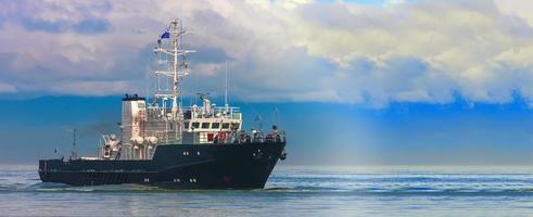 petit bateau en mer bleue près de la côte photo