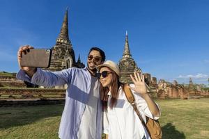 deux touristes étrangers prennent une photo de selfie au temple wat phra si sanphet, ayutthaya thaïlande, pour les voyages, les vacances, les vacances, la lune de miel et le tourisme