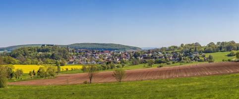 champ de colza jaune près de la ville de rhoden en allemagne pendant la journée photo