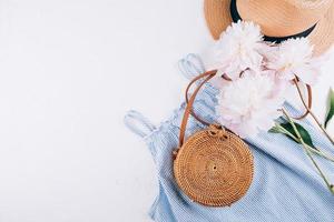 vêtements d'été de mode pour femmes, accessoires. chapeau de paille femme élégant, robe bleue, sac en rotin, pivoine photo