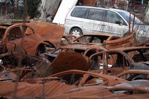 Vieux champ de voiture rouillée de dépotoir photo