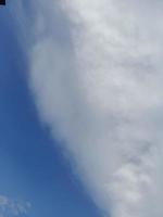 beaux nuages blancs sur fond de ciel bleu profond. image élégante de ciel bleu à la lumière du jour. de grands nuages doux et moelleux couvrent tout le ciel bleu. photo