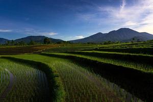 vue aérienne de la zone rurale indonésienne avec montagnes et rizières le matin photo