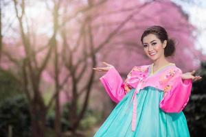 hanbok, la robe coréenne traditionnelle et belle fille asiatique avec sakura photo