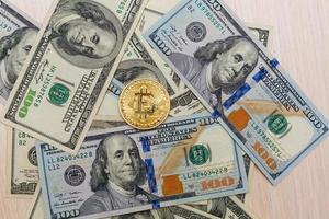 Pièce d'or bitcoin sur dollars américains close up